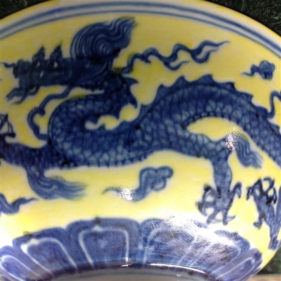 A Chinese yellow ground dragon and phoenix bowl, Xuande six character mark and possibly of the period, 19.5cm, museum restoration, sc